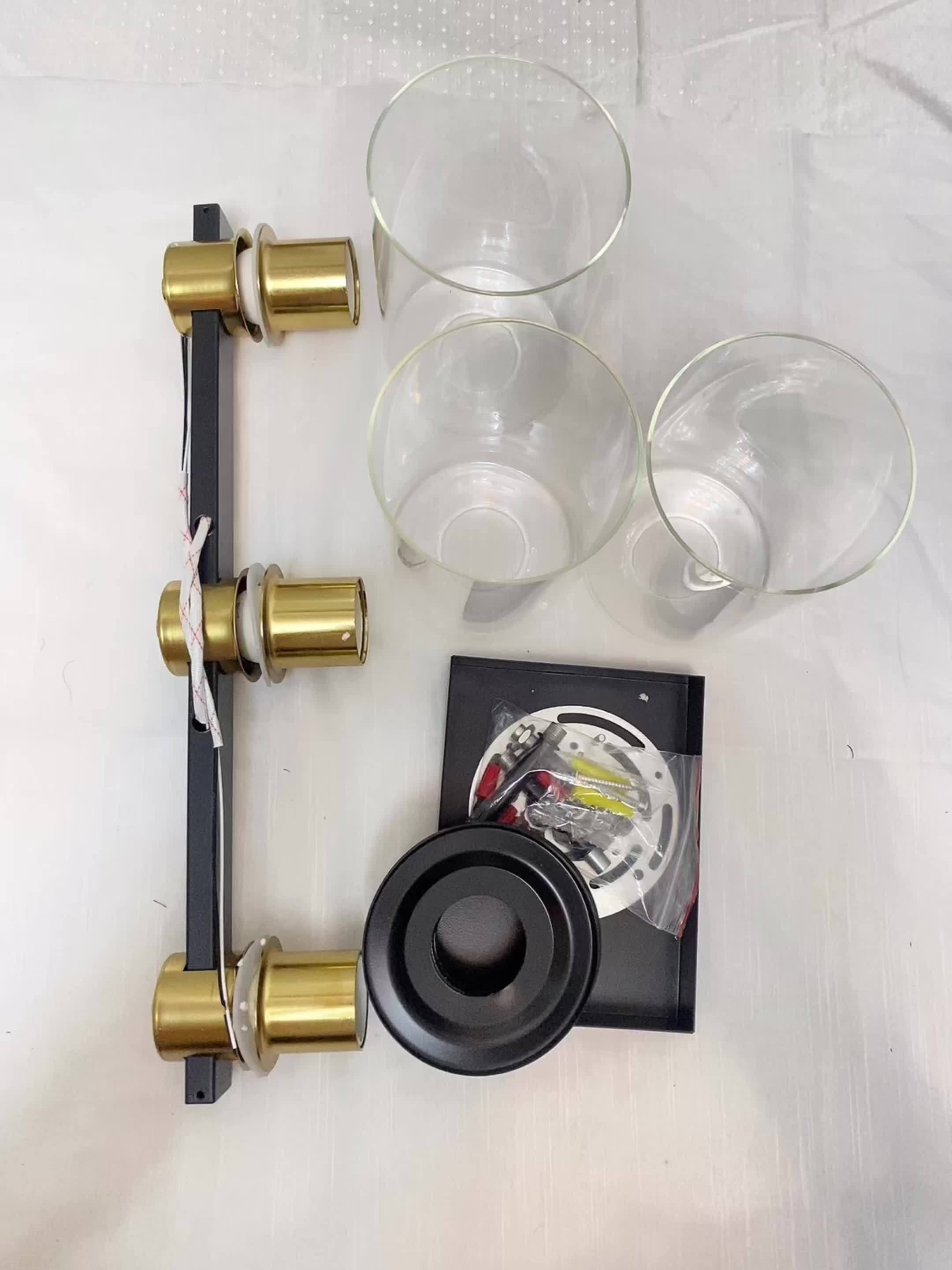 Three Black And Golden Light Fixtures for a Bathroom Vanity Above The Mirror, a Four-Light Modern Brass Wall Sconce Featuring a Glass Ball Shade, And Mid-Century Farmhouse Vanity Lighting (Bulb Not Included).